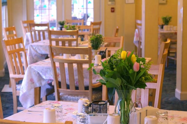 Dining area with tables and floral centerpieces
