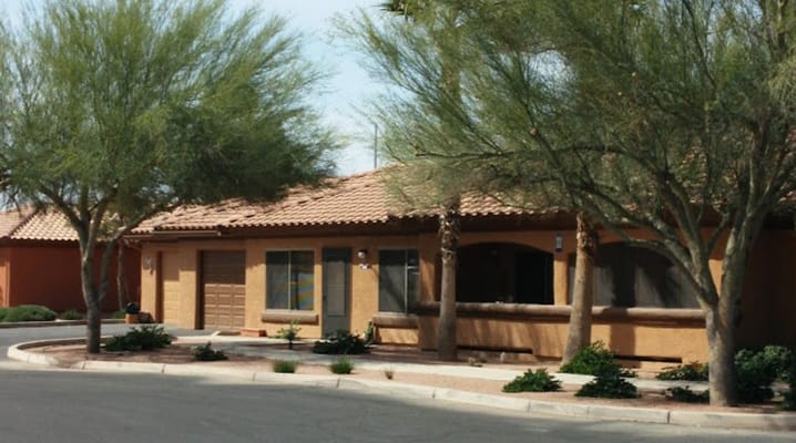Exterior of a senior living villa surrounded by trees