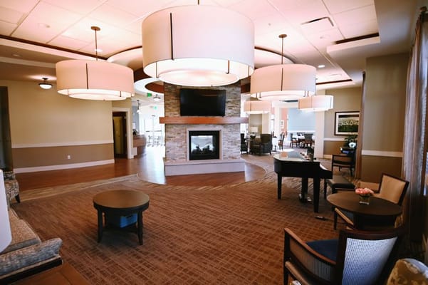 Bright common area with seating and a fireplace