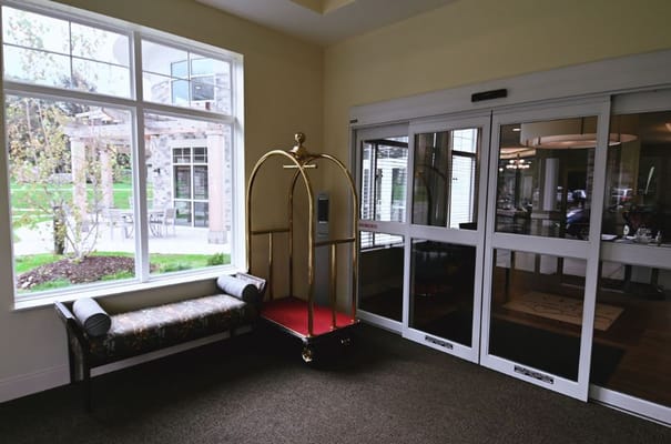 Interior view of a lobby with a luggage cart