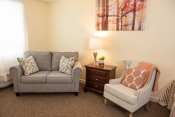 Cozy interior seating area with a sofa and lamp