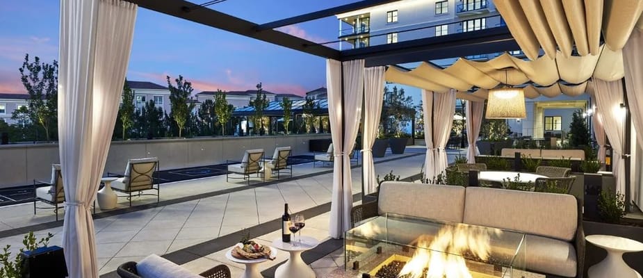 A stylish outdoor lounge area with seating and fire pit