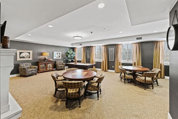 Bright common area with seating and gaming tables