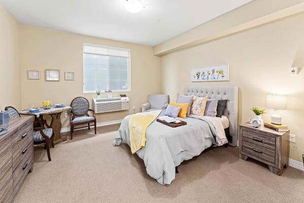 Cozy resident room with a bed and seating area