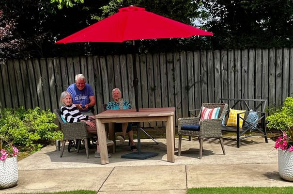 Residents enjoying a sunny outdoor garden area