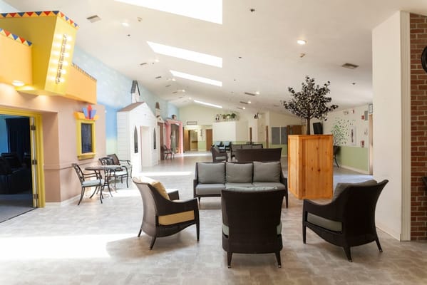 Bright common area with seating and decorative walls