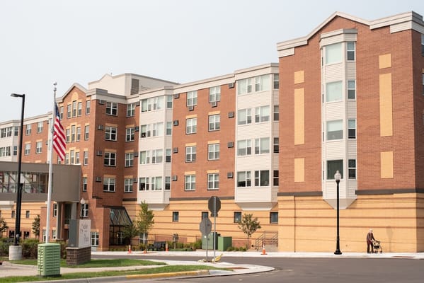 Exterior view of a senior living facility with landscaping