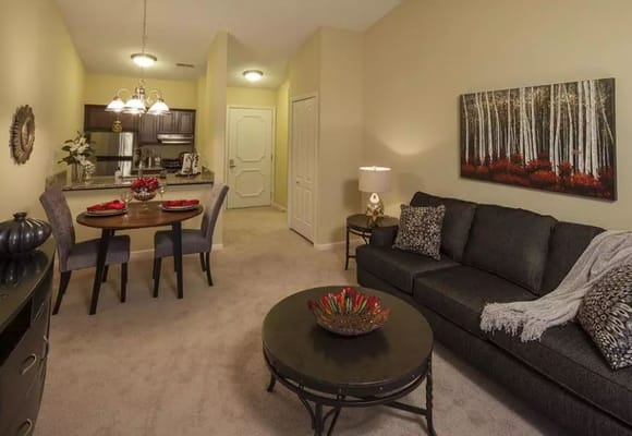Cozy living area with a dining table, modern kitchen, and decorative art