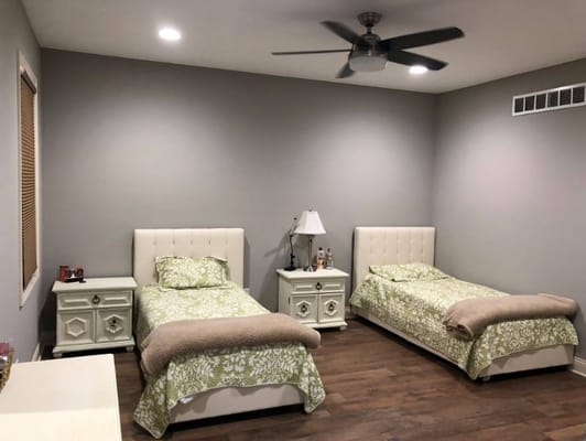 Two twin beds in a softly lit room