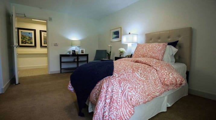 Comfortable bedroom with a bed and side table in Welbrook Santa Monica.