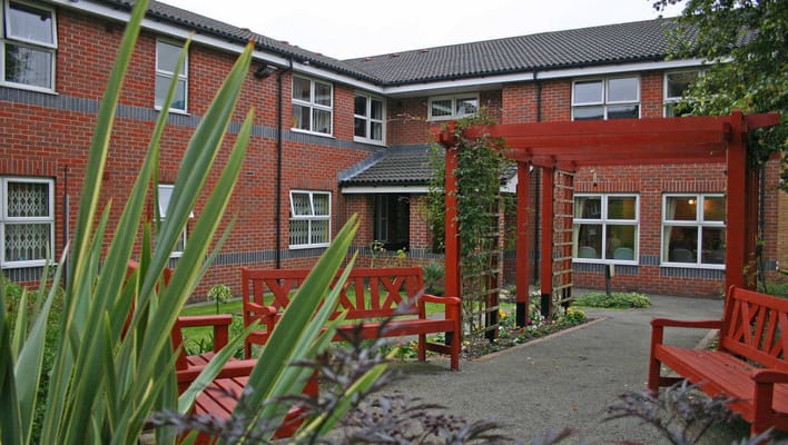 Outdoor seating area surrounded by greenery