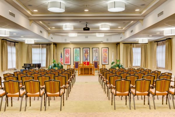 Interior view of an activity room with chairs and stage