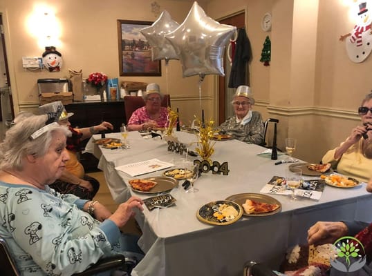 Residents celebrating with food and decorations in a common area