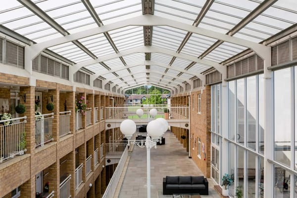 Bright atrium area with seating and indoor plants