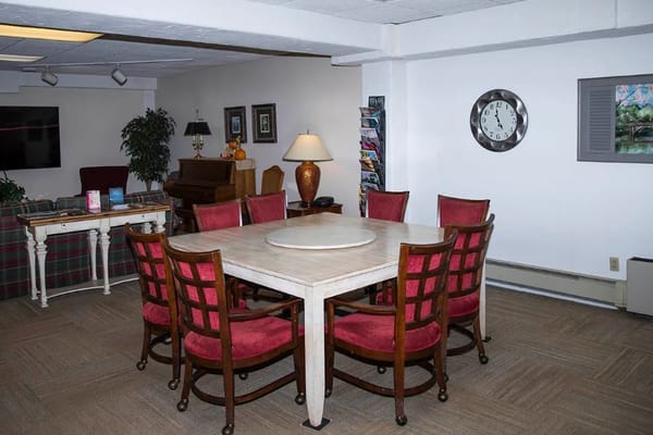 A cozy common area with a table and chairs