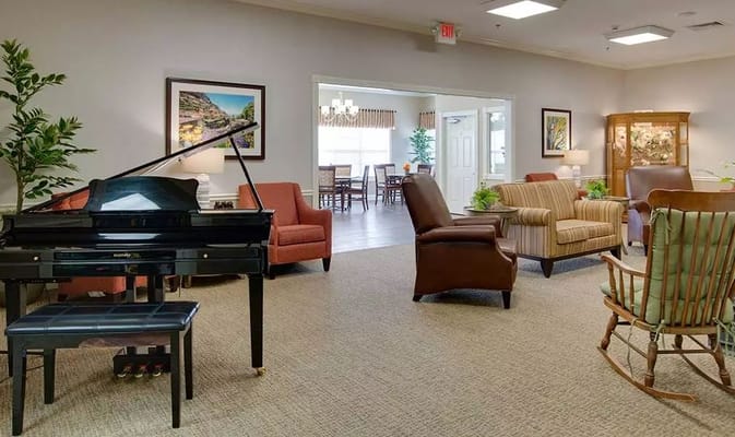 Living room featuring a piano and comfortable seating areas.