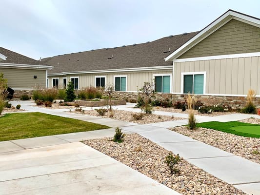 Pathway through landscaped outdoor area with building
