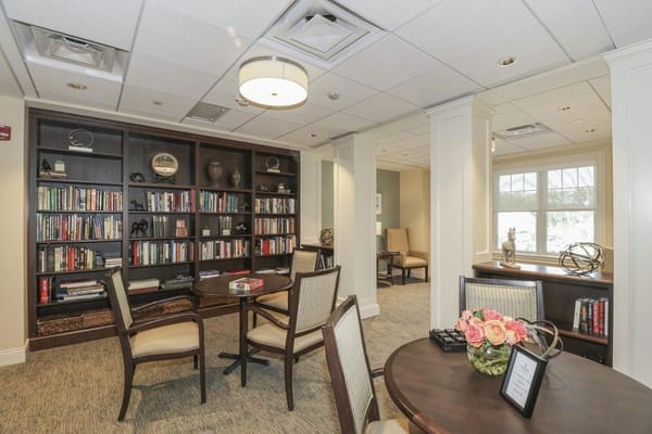 Cozy library lounge with bookshelves and seating area