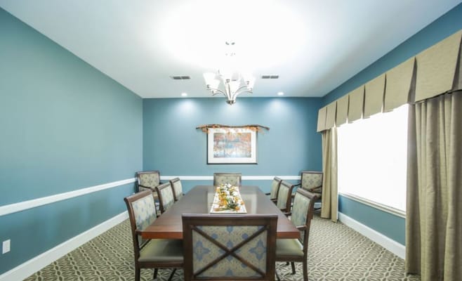 Cozy dining room with a long table and seating at Whitley Place.
