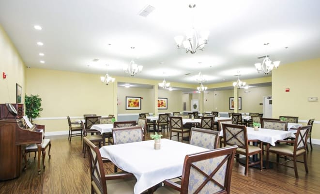 Brightly lit dining room with tables and chairs in Whitley Place.