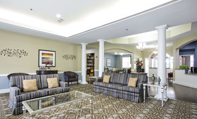 Spacious living room with striped sofas and decorative elements