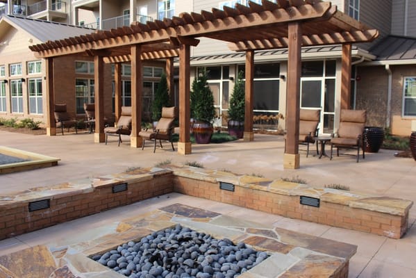 Outdoor seating area with a pergola and stone features