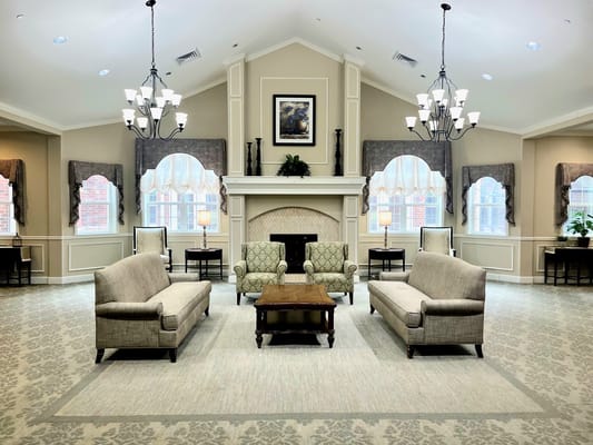 Comfortable living room with sofas and a fireplace in Willow Fork Alzheimer's Special Care Center