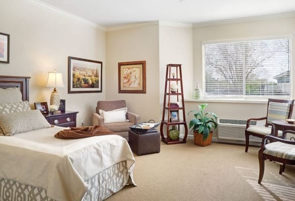 Cozy resident room with a bed and seating area