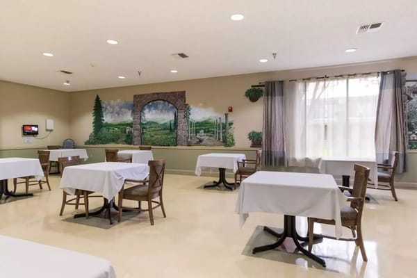 Dining room with tables and a mural at Windsor Nursing and Rehabilitation Center