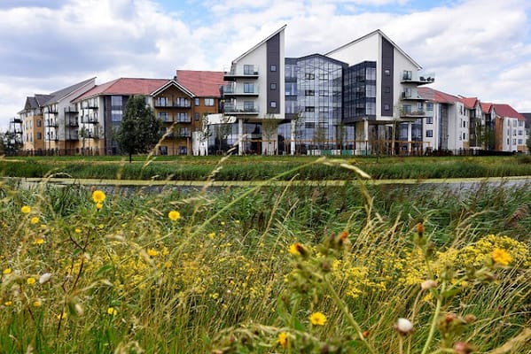 Exterior view of Wixams Retirement Village surrounded by flowers