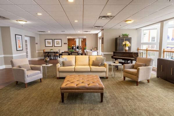 Bright common area with seating and piano