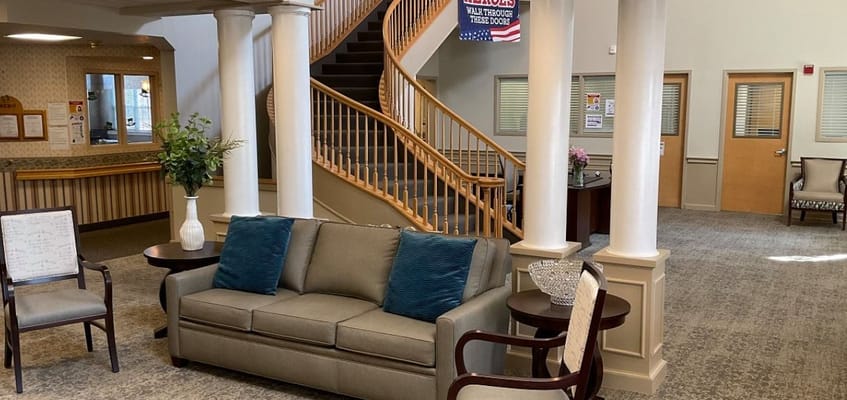 Bright common area with seating and a staircase