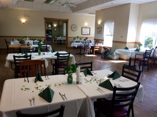 Bright dining room with neatly set tables.