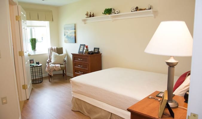 Cozy resident room with a bed and seating area