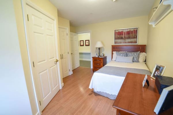 Cozy resident room with a bed and dresser