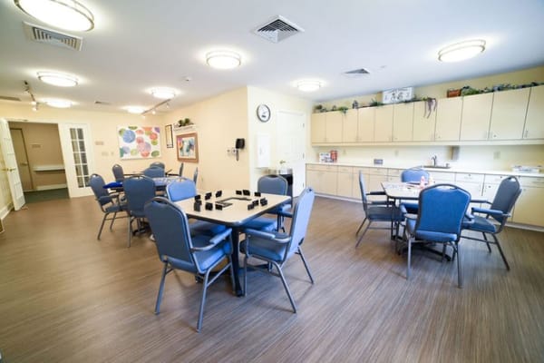 Bright activity room with tables and chairs