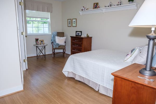 Cozy resident room with a bed and seating area