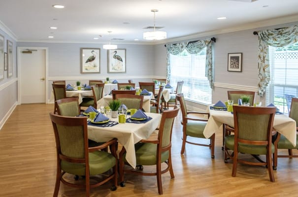Bright dining room with tables set for meals