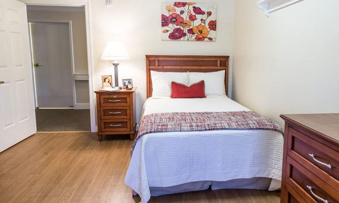 Cozy private resident room with bed and decor