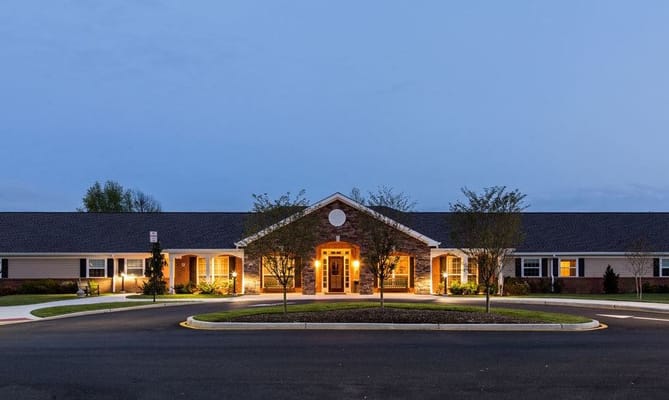 Exterior view of the senior living facility at dusk