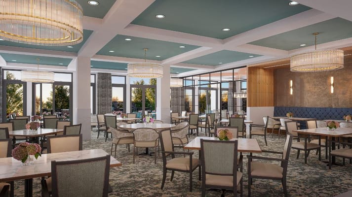 Bright dining area with tables and chairs set up