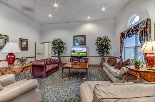 A cozy living room with seating and a television.