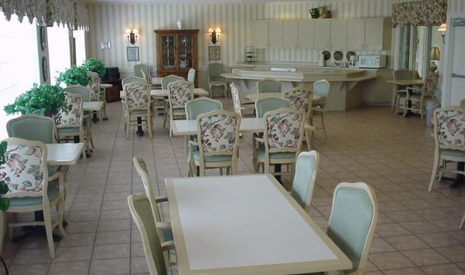 Bright dining area with tables and floral chairs