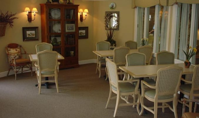 A common area with tables, chairs, and decor in Callaway Gardens.