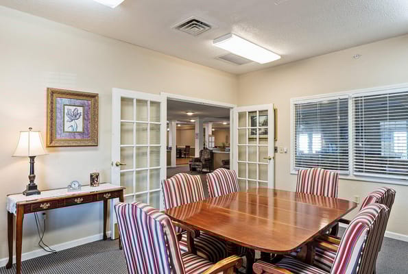 Dining area with wooden table and striped chairs