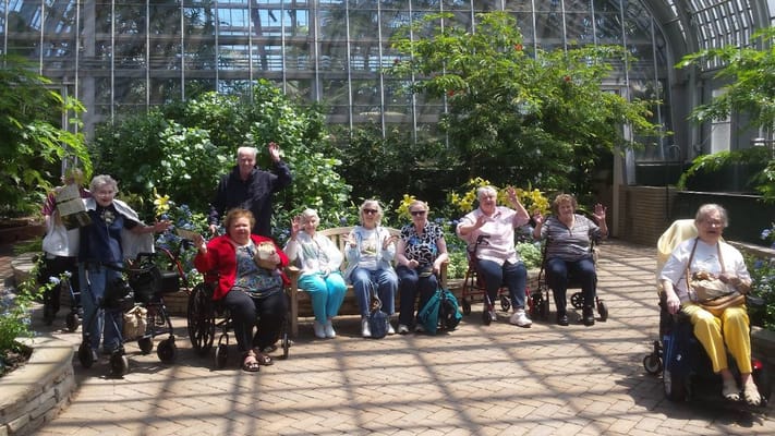 Residents enjoying time together in a greenhouse