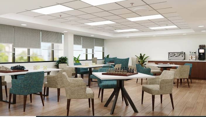 Common area with tables and chairs for activities