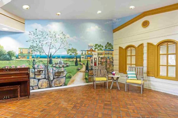 Brightly painted lobby with seating and a mural