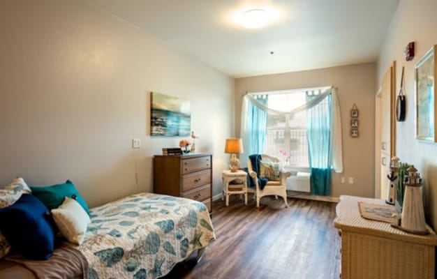 Bright and inviting bedroom with a bed, dresser, and window
