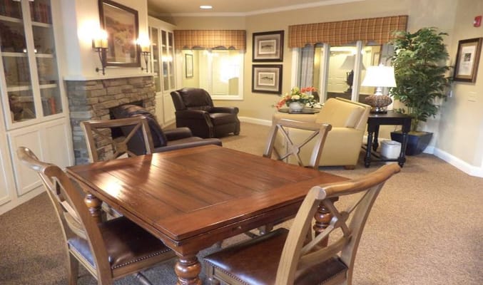 Cozy common area with a wooden table, chairs, and comfortable seating